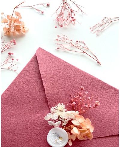 Decoration of pink dried flowers on envelopes and sealing wax seals